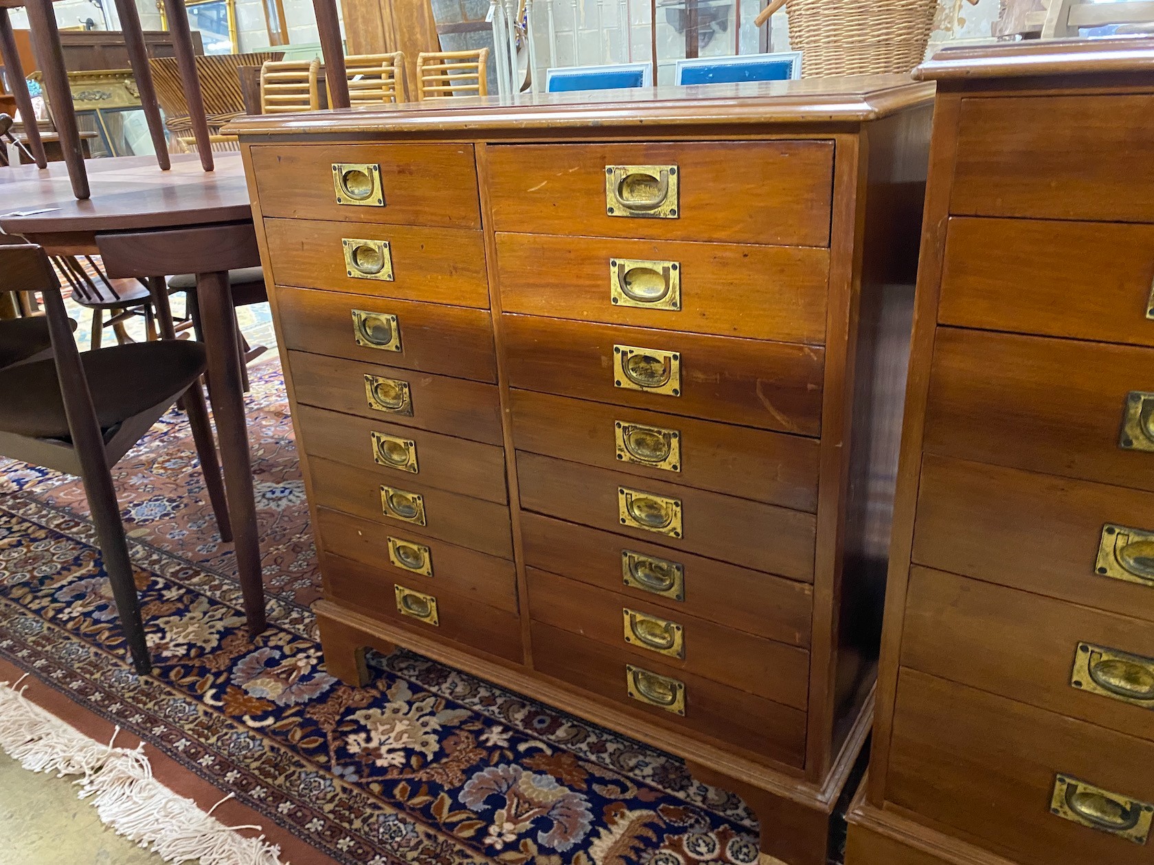 A near pair of mahogany and walnut military style chests of drawers, larger width 82cm, depth 54cm, height 85cm